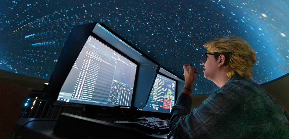An astronomy students works in UM's planetarium.