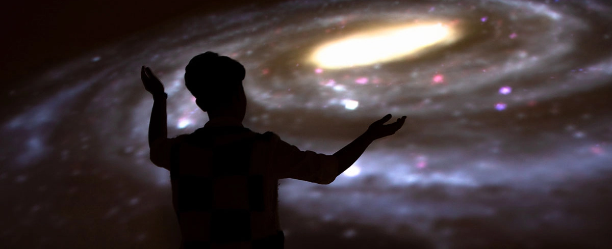 A student leads a presentation in UM's planetarium