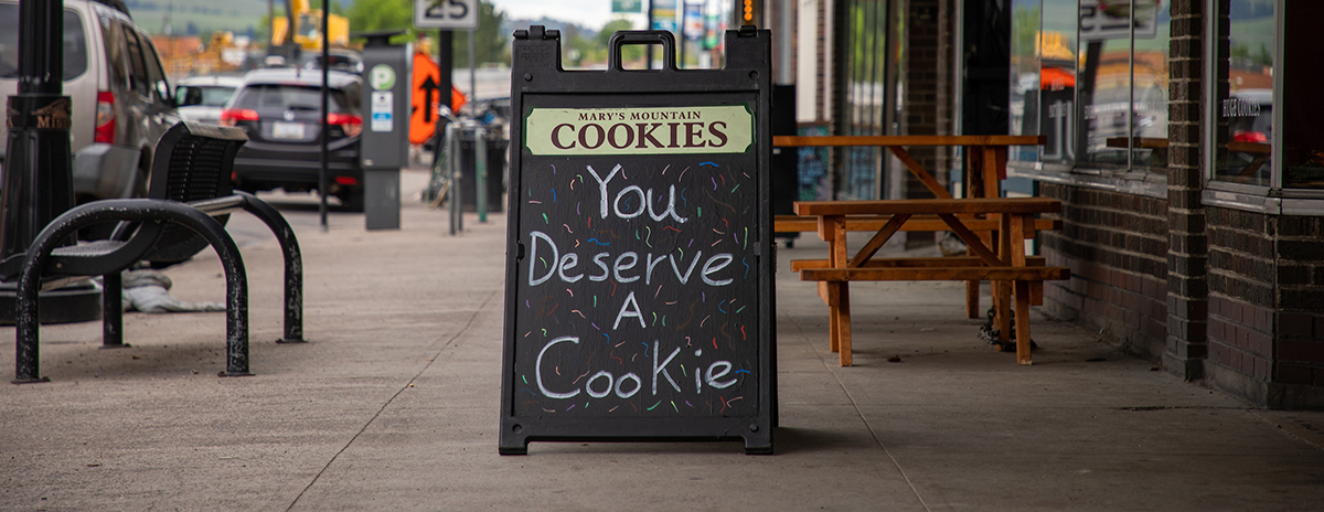 A sandwich board sign outside a Missoula shop reads: You deserve a cookie