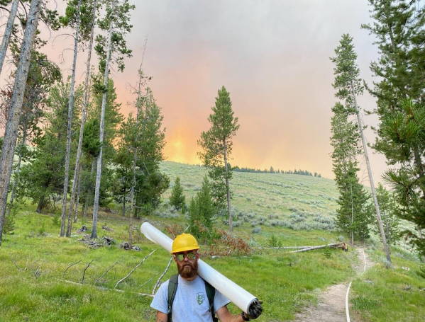 Nate Gowen Hiking off of Battle Mountain at Big Hole National Battlefield after fire wrapping culturally significant resources to protect them from the encroaching Trail Creek wildfire in 2021.