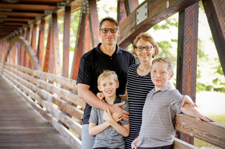 Dr. Rob Cruikshank and Family standing on a bridge