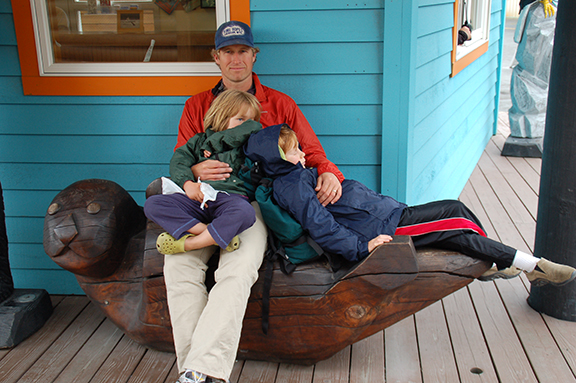 Professor Lowe with his children in a seal-shaped bench in Alaska
