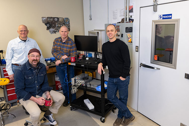 Pictured outside the center’s environmental chamber are (left to right) Robert “Trey” Coker, Brent Ruby, Dustin Slivka and Walter Hailes. 