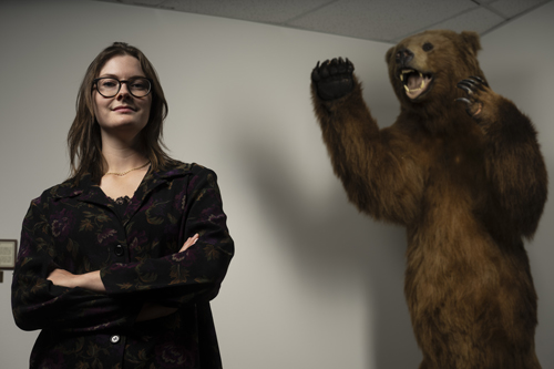 Ruby Schipf poses with a taxidermy bear on the UM campus.