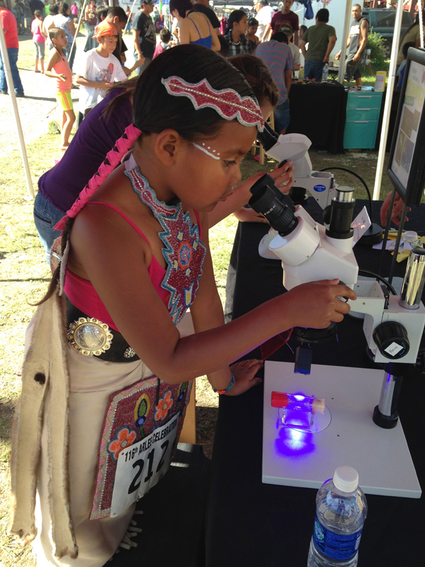 Native girl on microscope